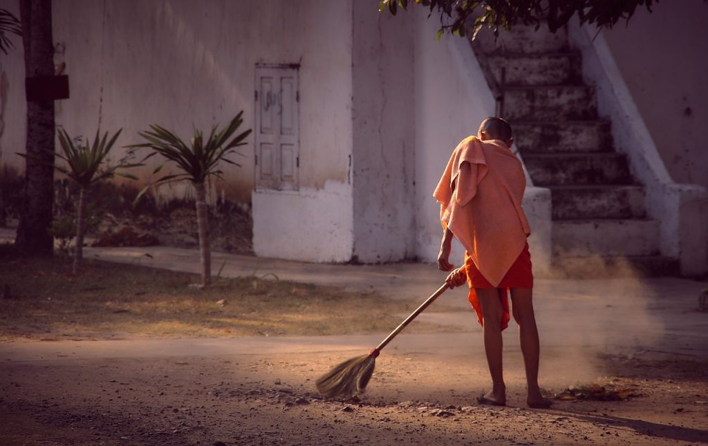 Monk cleaning street